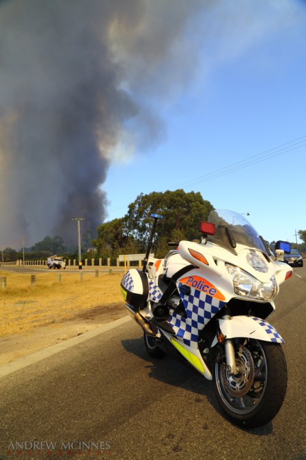 Police road block as a bushfire rages at Banjup, Western Australia.